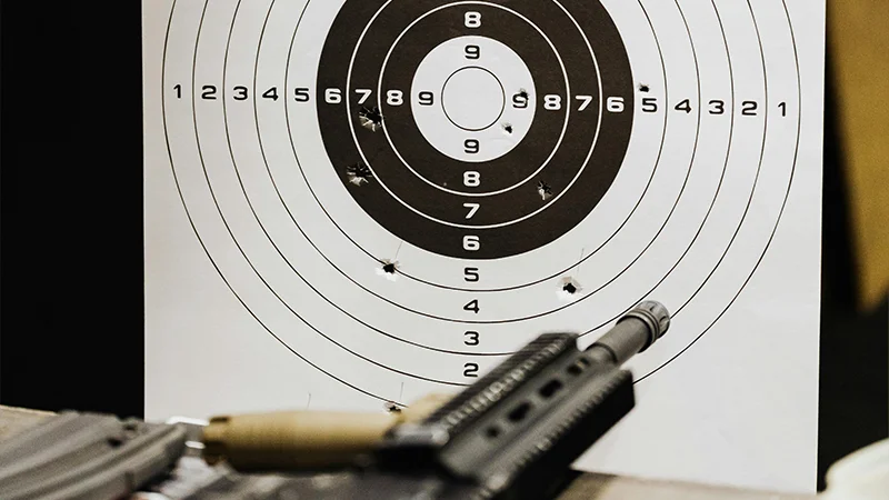 Instructor leading multi-tier firearms instruction at the range