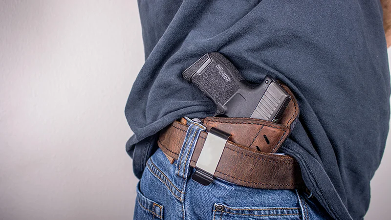 Instructor coaching concealed carry draw technique